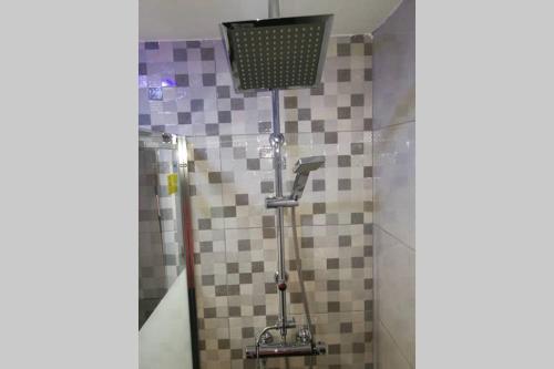 a bathroom with a shower with a tiled wall at Apartamento Centrico , Wifi + Desayuno in Logroño