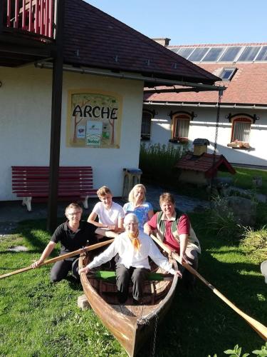 a group of people sitting in a wooden boat at Biolandhaus Arche in Eberstein