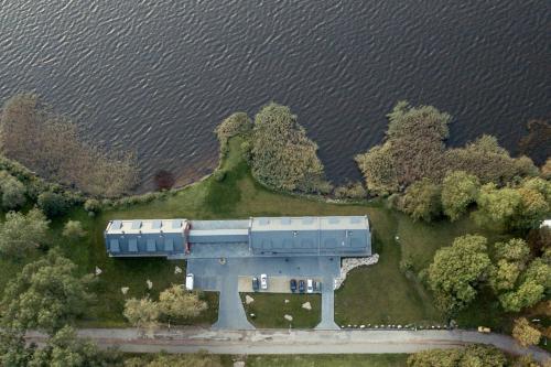 an aerial view of a train on an island in the water at Žvejų užeiga in Šiauliai