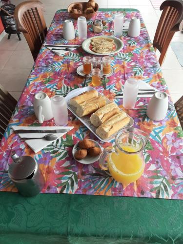 a table with a table cloth with food on it at La kazanou in Saint-Joseph