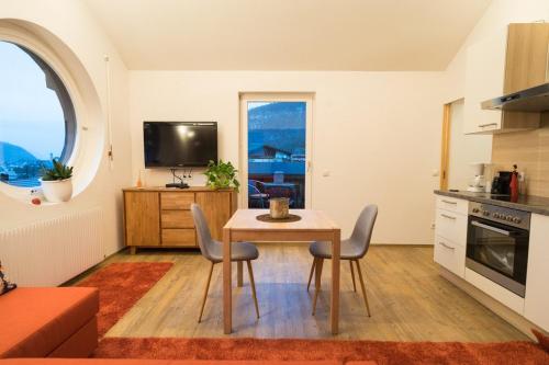 a kitchen and dining room with a table and chairs at Appartement Christiane in Bludenz