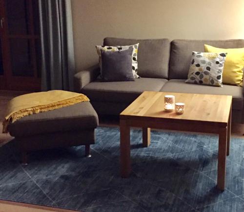 a living room with a couch and a coffee table at LICHTECK - Helle Ferien in Breitenberg