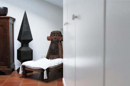 a room with a wooden chair in a room at Casa Chiara Plus in Porto Recanati