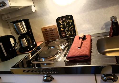 a stove top with pots and pans on it at Apartment Lintu in Mikkeli