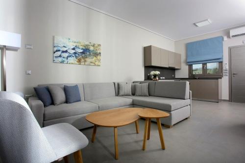 a living room with a couch and a table at Lagouvardos Village Hotel in Marathopolis