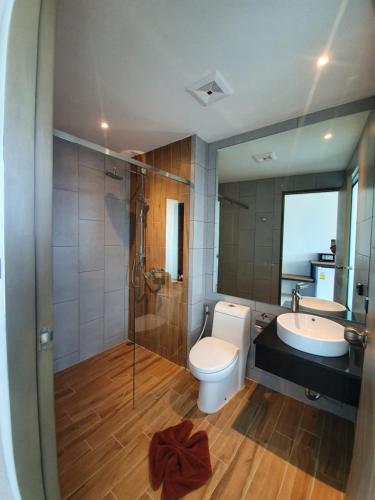 a bathroom with a toilet and a sink and a shower at Atom Phuket Hotel -SHA Plus in Nai Yang Beach