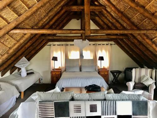 a bedroom with a bed and a couch in a attic at The Loft in McGregor in McGregor