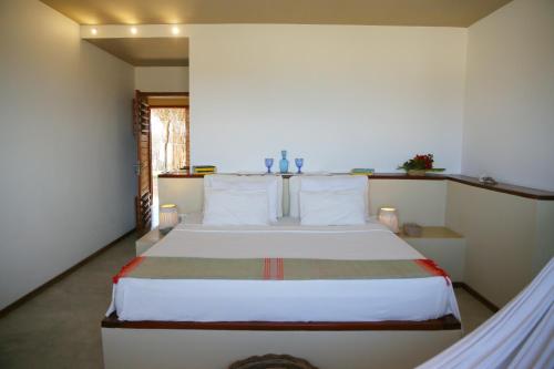 a bedroom with a large bed in a room at maison au zenit in Maceio