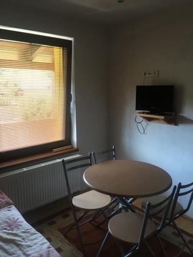 a table and chairs in a room with a window at Miroslav Bednár-Bedomir in Huta