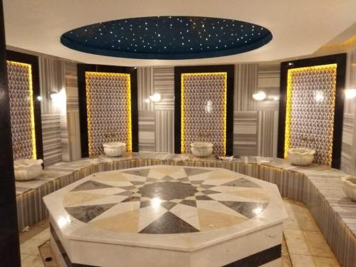 a large room with a table in the middle of it at Granada City Alanya Luxury Appartment 800м от пляжа Клеопатра in Alanya