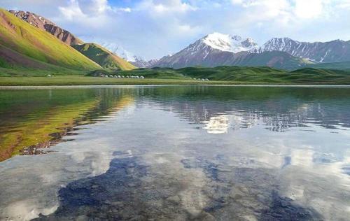 a large body of water with mountains in the background at PAMIR NOMAD Yurt Camp in Kara-Kavak