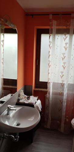 a bathroom with a sink and a window at La Villa in Arco