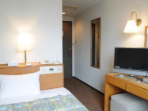 Smile Hotel Nihombashi Mitsukoshimae tesisinde bir odada yatak veya yataklar