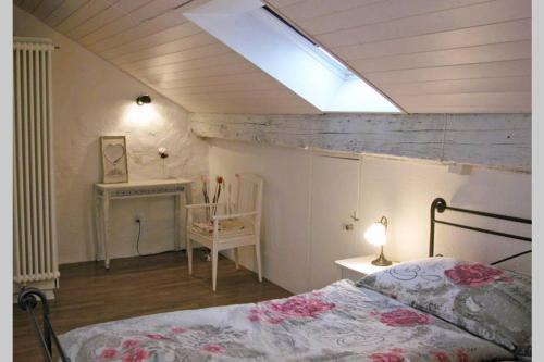 a bedroom with a bed and a skylight at Joline private guest apartment downtown Nidau in Nidau
