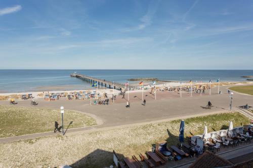 a view of a beach with a pier and chairs at Traum Ostseemeerblick in Schönberger Strand