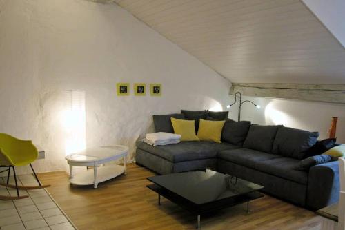 a living room with a couch and a table at Joline private guest apartment downtown Nidau in Nidau
