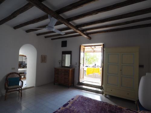 a living room with a door leading to a patio at Casa del Limone in Filicudi