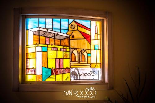 a window with a stained glass window of a church at Suite San Rocco Wellness&Spa in Ruvo di Puglia