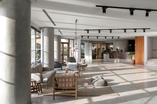 a lobby with couches and chairs in a building at Blue Sky City Beach Hotel in Rhodes Town