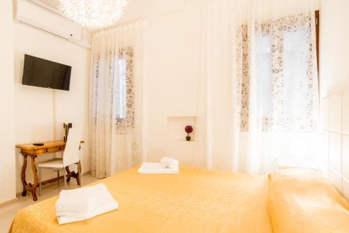 a bedroom with a bed and a desk and a table at Lovely in San Marco in Venice