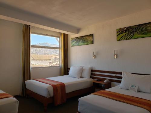 En eller flere senge i et værelse på Hotel Sueños del Inka