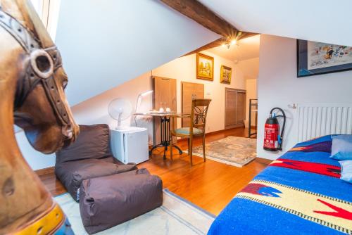 a room with a bed and a couch and a table at Domaine du Pressoir in Ambilly