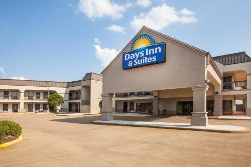 a days inn and suites sign on the front of a building at Days Inn & Suites by Wyndham Tyler in Tyler