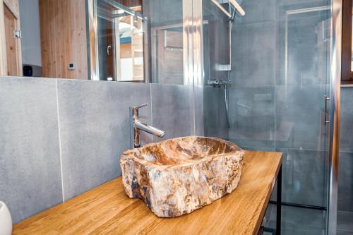 a bathroom with a stone sink on a wooden counter at Bury Miś in Jaworki
