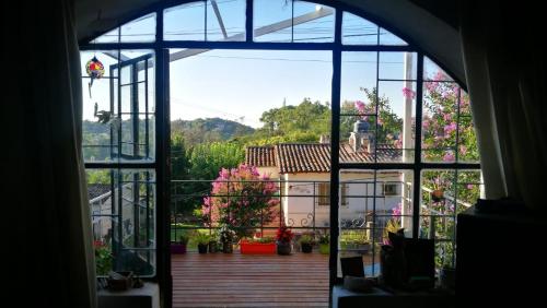 a view from a window of a patio with flowers at Habitación en Casa Las Dos Nenas in Río Ceballos