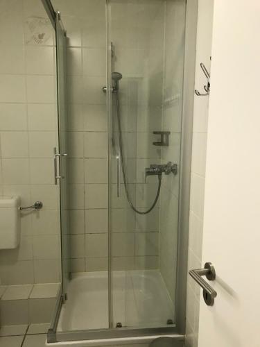 a bathroom with a shower with a glass door at 2 Room Messe Kongress Stadion in Dortmund