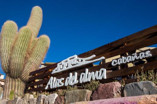a sign in front of a cactus at Alas del Alma in Tilcara