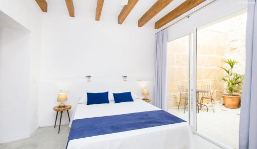 sypialnia z łóżkiem i dużym oknem w obiekcie Sa Granada w Manacorze