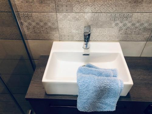 a sink in a bathroom with a towel on it at Apartment Karin in Rijeka