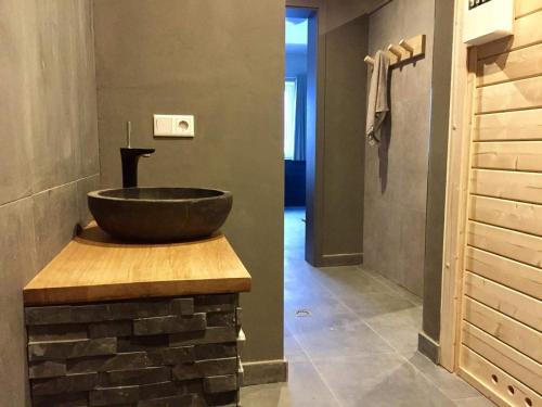 a bathroom with a bowl sink on a brick wall at Villa Silberberg in Winterberg