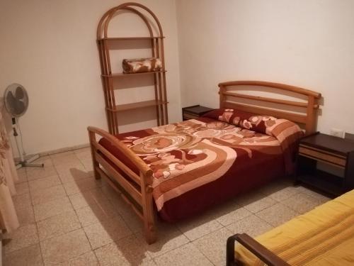 a bedroom with a bed and a book shelf at Habitaciones Javi Los Abrigos in Golf del Sur