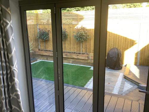a sliding glass door leading to a backyard with a pool at Carolyn’s Place in Ruislip