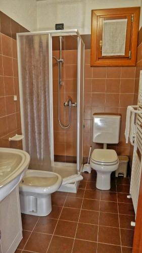 a bathroom with a shower and a toilet and a sink at hotel Vajont in Vaiont