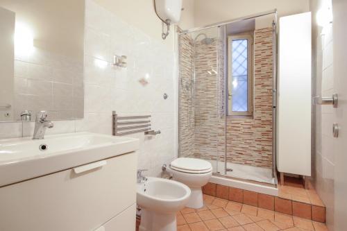 e bagno con servizi igienici, lavandino e doccia. di Le Piazze di Roma Sweet Apartment a Roma