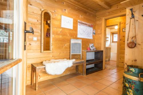 a cabin with a bench and a tv in a room at AlpenApart Montafon - Bitschweil Hüsle in Schruns