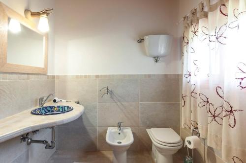 a bathroom with a toilet and a sink at LA CESA Holiday House in San Felice Circeo