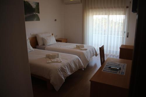 
Uma cama ou camas num quarto em Hotel Solar da Charneca
