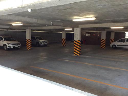 a parking garage with cars parked in it at Hotel Hi! Queretaro in Querétaro
