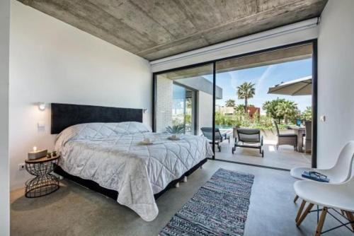 a bedroom with a large bed and a patio at VILLA BEAU in Ferragudo