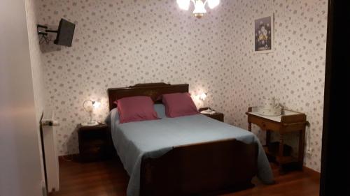 a bedroom with a bed and a lamp at Valentine 44 in Sainte-Mère-Église