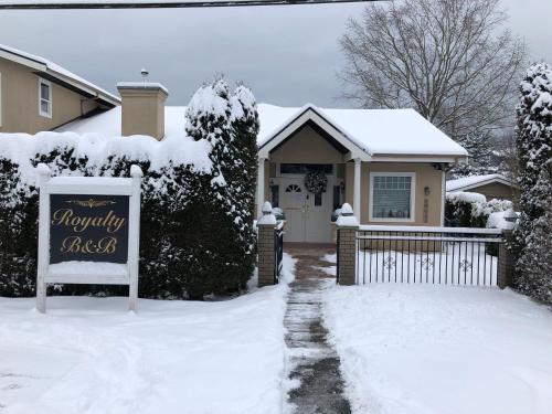 
a snow covered street with a house at Royalty B&B in Richmond
