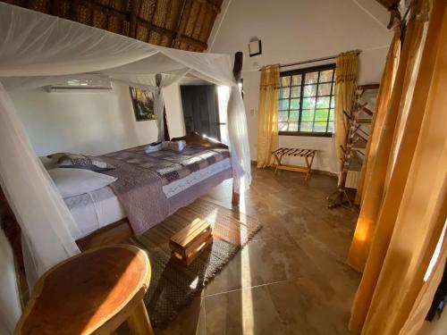 een slaapkamer met een hemelbed in een kamer bij Quetzal Dorado Eco-Lodge in El Zaino