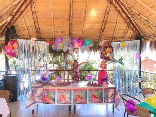a birthday party with a table and balloons at Hotel Villa Amparo in Chinauta
