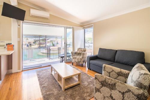 a living room with a couch and a table at Ingenia Holidays Hunter Valley in Cessnock