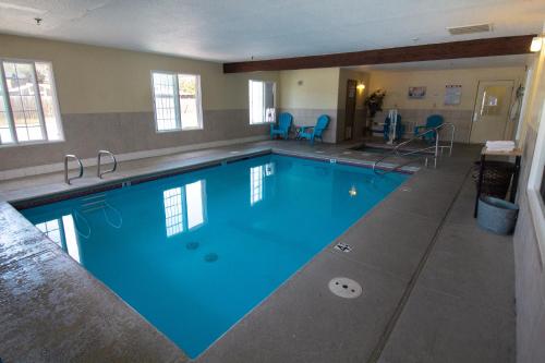 a large swimming pool with blue water in a building at FairBridge Inn & Suites Kellogg in Kellogg