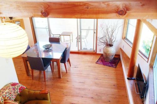 a dining room with a table and chairs at Woody house in Nakano